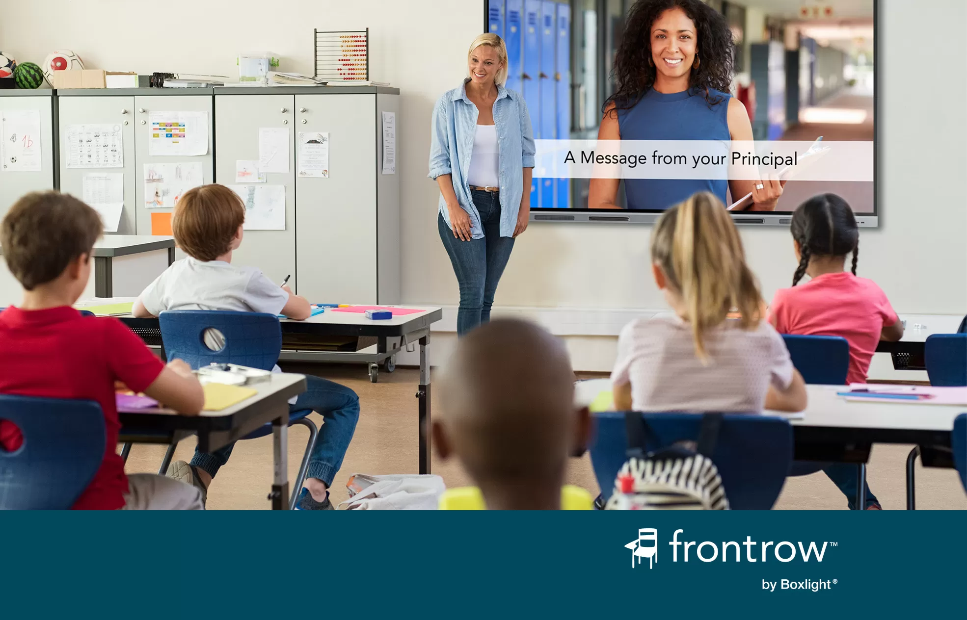 attention! used in a classroom to share a message from the principal with a blue banner saying 'FrontRow by Boxlight' across the bottom