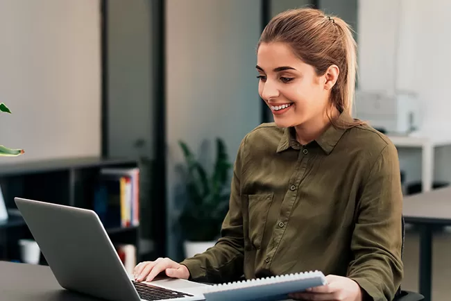 person smiling on a laptop