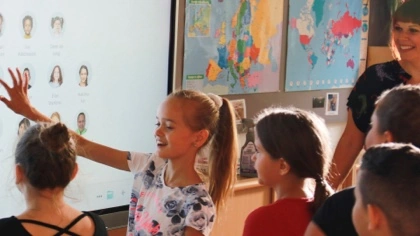 Students using a MimioPro 4 interactive display screen in a classroom