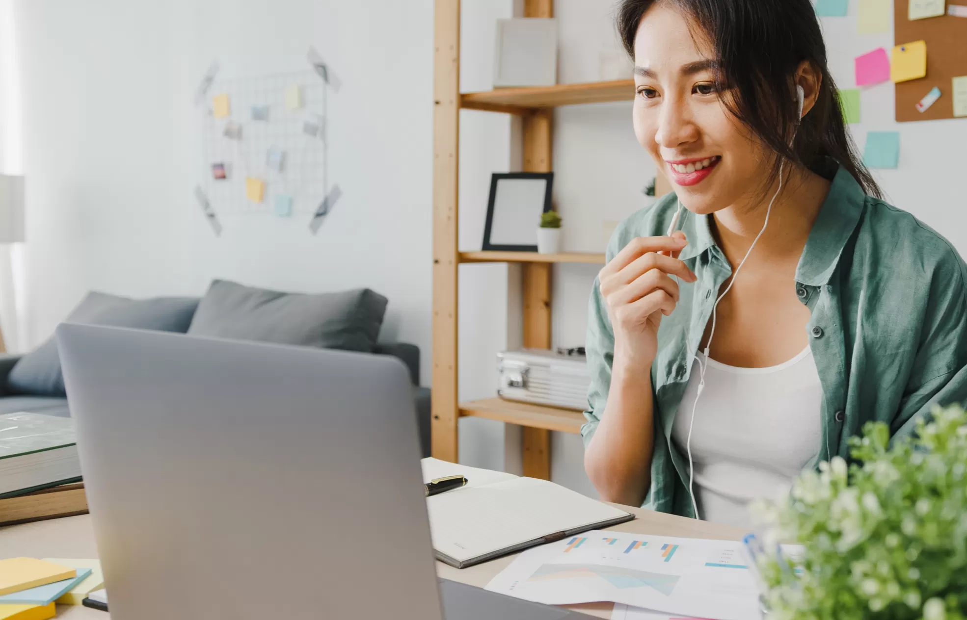 person smiling at a laptop